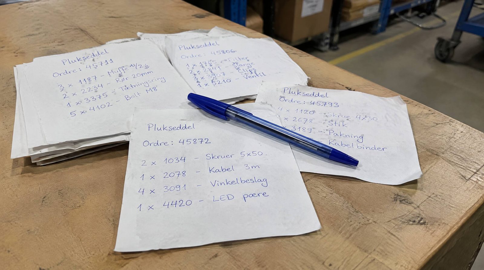 Bunke håndskrevne pluksedler på et bord